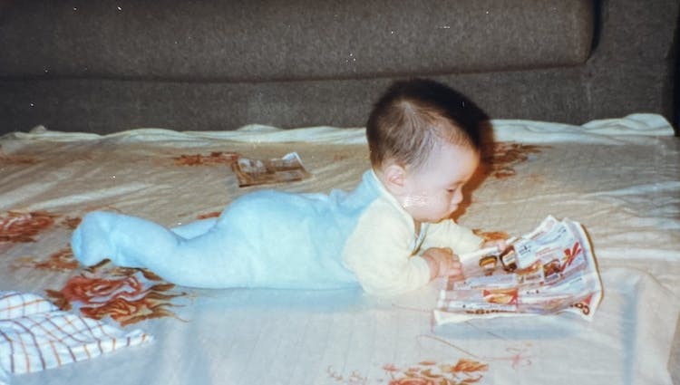 Troy as a baby, reading